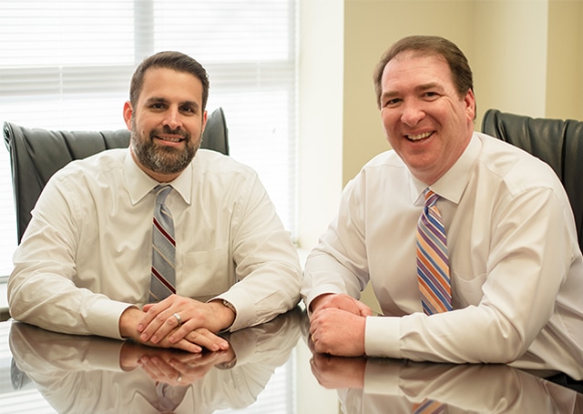 Alex Gordon and Carlos Wall sitting in their office